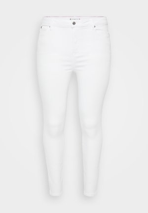 White skinny jeans made of denim with a smooth texture, featuring a front button closure and belt loops. No visible patterns or accents.