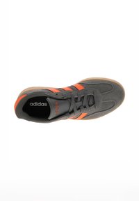 Gray suede sneaker with orange stripes, rubber sole, and lace-up closure. Features padded collar and logo on the tongue.