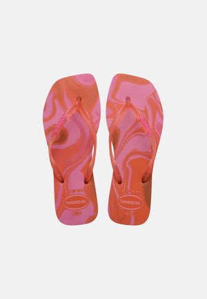 Pair of orange and pink patterned flip-flops with textured soles and branded straps, laid flat on a white background.