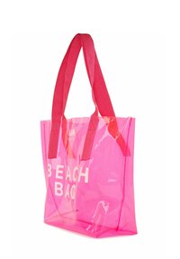 Prozoren roza torba za plažo z rdečimi tekstilnimi ročaji, ki vsebuje besedilo "BEACH BAG" v beli barvi. Torba ima odprto zgornjo stran in pravokotno obliko.