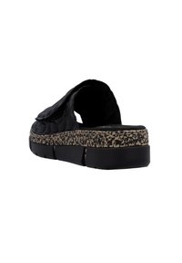 Black slip-on shoe with textured upper, thick foam sole featuring a patterned midsole, and no back support.
