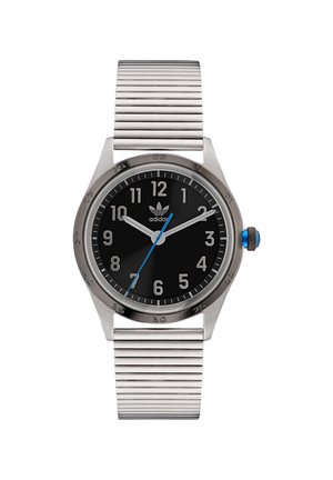 Montre en acier inoxydable avec un cadran noir, des marqueurs d'heure blancs, une aiguille des secondes bleue et un bracelet en argent strié. Présente un logo Adidas sur le cadran.