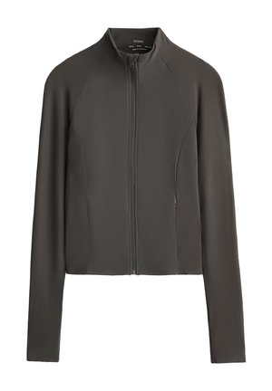 Veste zippée grise avec une texture côtelée, un col montant et des manches longues, dotée de deux poches latérales et d'une coupe ajustée.
