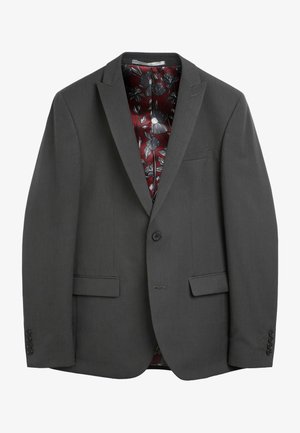 Sivi sako s nazubljenim reverima, zatvaranjem na jedan gumb i tri prednja džepa. Podstavljen crvenim cvjetnim uzorkom.