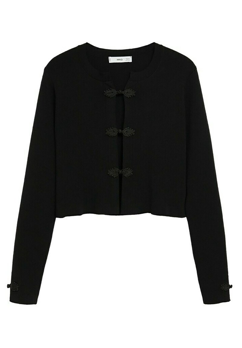 Mustavihreä lyhyt neulejakku pitkillä hihoilla, pyöreällä kaula-aukolla ja koristeellisilla sammakon sulkimilla edessä ja hihoissa. Sileä, teksturoitu kangas.