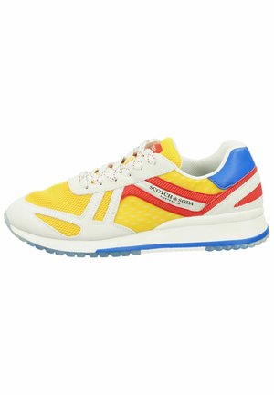 Sneaker with a mesh yellow upper and white accents, featuring red and blue details, textured surfaces, and a clear rubber sole.
