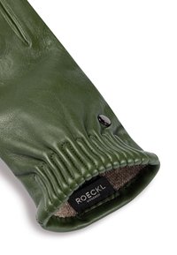 Green leather glove with elastic wrist, button snap, and visible fabric lining featuring "ROECKL München" label.