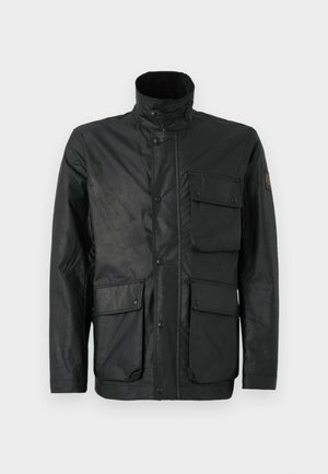 Black jacket made of textured fabric, featuring a high collar, snap buttons, and four front pockets. Includes logo patch on the sleeve.