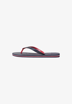 Flip-flop with a navy rubber sole, red and grey straps, textured footbed, and white stripes along the edge. Designed for casual wear.