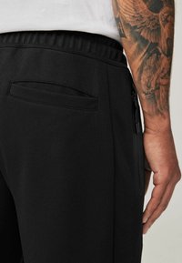 Next REGULAR FIT - Tepláky - black