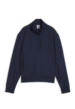 Pull-over manches longues bleu foncé en tissu texturé, col montant et courte fermeture éclair à l'avant, présenté sur fond blanc.