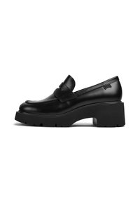 Mocasín de cuero negro con tacón grueso y suela gruesa, con un detalle de correa en la parte superior, mostrado de lado sobre un fondo blanco.