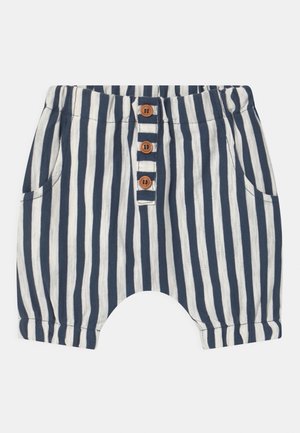 Granatowo-białe niemowlęce spodenki z pionowymi paskami, z elastycznym paskiem w talii, trzema drewnianymi guzikami z przodu oraz bocznymi kieszeniami.