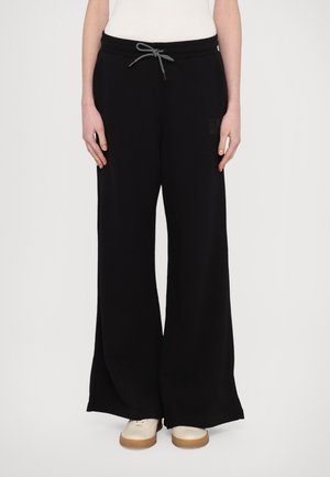 Zwarte wijde sweatpants gemaakt van zachte stof, met een drawstring tailleband en een klein logo detail aan de zijkant.