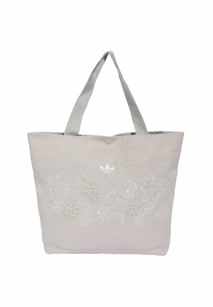 Sac fourre-tout gris clair avec larges poignées et broderie florale blanche subtile sur le devant, avec un petit logo Adidas au-dessus du design.
