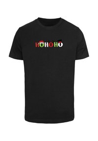 Sort bomulds t-shirt med "HO HO HO" design og festlige detaljer: røde og grønne bogstaver, en juleslædehat, et rensdyrhorn og en ananas hat.