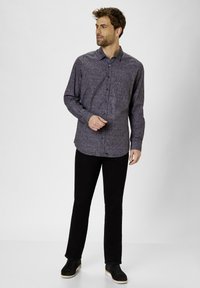 Long-sleeve, button-up shirt in dark purple with a subtle pattern, paired with black pants and dark boots. Clean lines and fitted design.