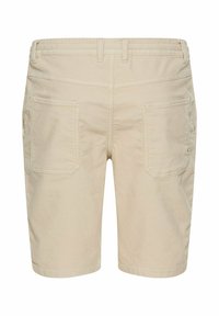 Beige Cord-Shorts mit geradem Schnitt, ausgestattet mit zwei Gesäßtaschen und einem elastischen Bund für zusätzlichen Komfort.
