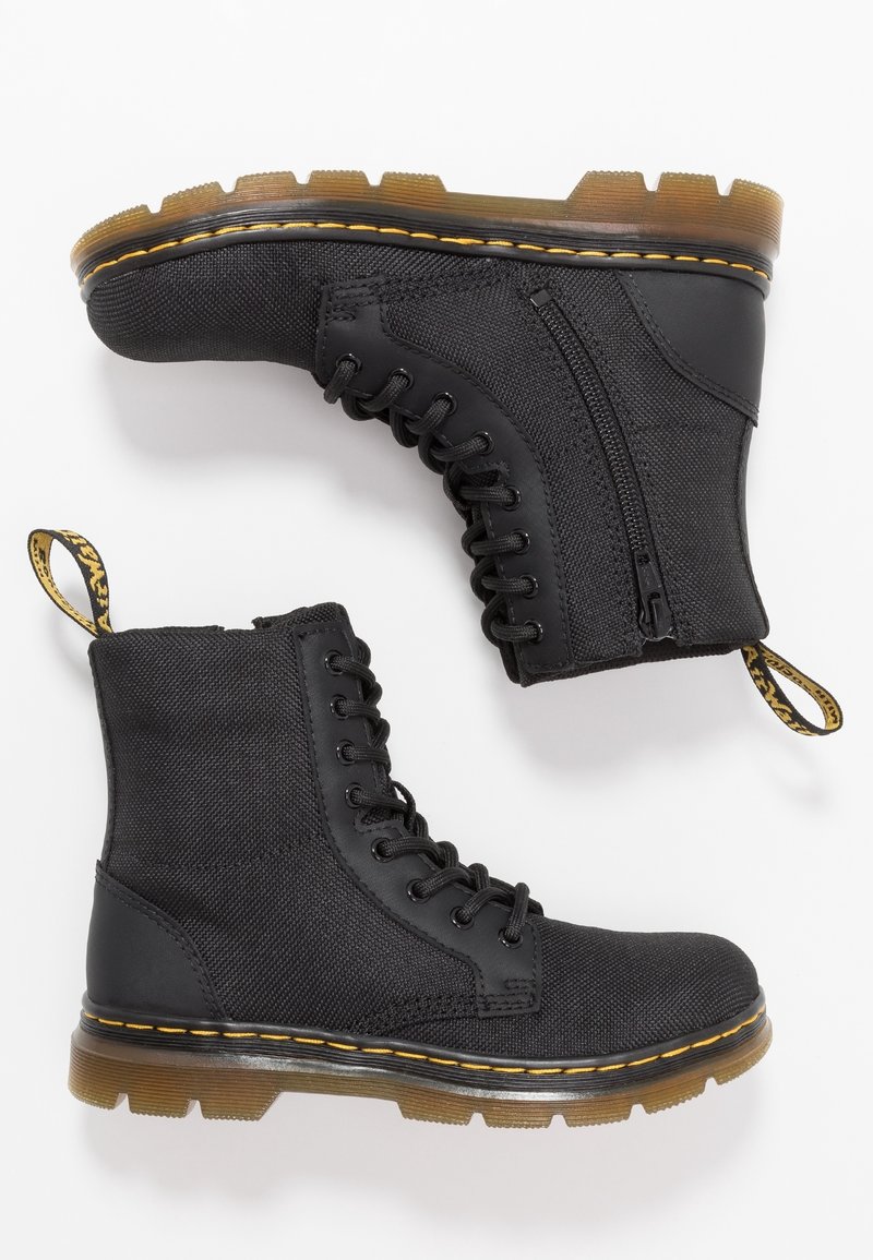 Black ankle boots made of durable fabric with a textured finish, featuring lace-up design, side zipper, and yellow stitching on a thick sole.