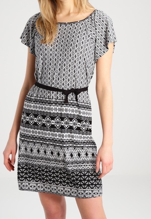 Robe à motifs noir et blanc avec un haut ample, une taille cintrée et une jupe évasée. Présente des motifs géométriques et un détail de ceinture nouée.