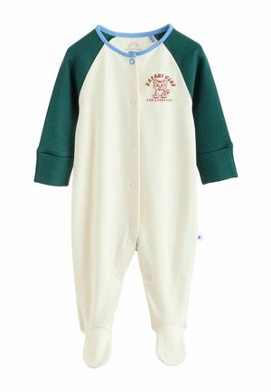 Kremfarvet onesie med grønne raglanærmer. Har en blå krave og trykknapper. Inkluderer "Safari Club" grafik på brystet.