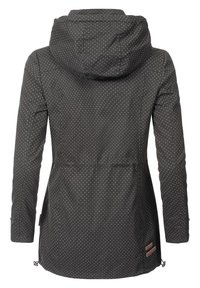 Black jacket with white polka dots, hood, drawstring waist, and zippered pockets. Features smooth, lightweight fabric and mid-length design.