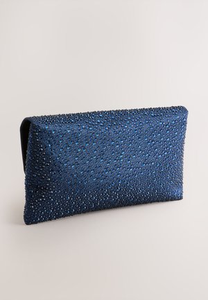 Sinine käekott, millel on tekstureeritud pind ja laiali laotatud sätendavad kivid. Ristkülikukujuline, stiilse disainiga ja kontrastse sisuga.