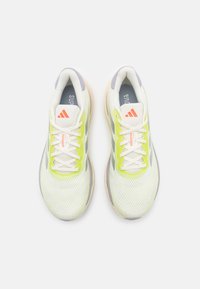 Lightweight running shoes with a white mesh upper, neon green accents, grey detailing, and white laces. Features a padded collar and tongue.