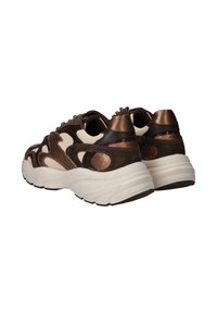 Bruine en crèmekleurige sneakers met gestructureerde accenten, voorzien van een dikke witte zool en gemengde materialen, waaronder suede en glanzende oppervlakken.