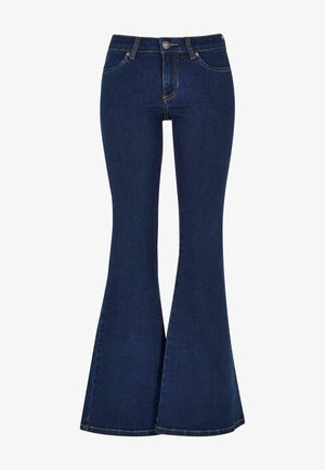 Mørkeblå denim bukser med sleng har høy midje, frontlommer og kontrastgult søm. Slengene på bunnen utvider seg gradvis.