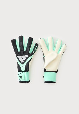 Paire de gants de gardien noirs, vert menthe et blancs avec doigts rembourrés et sangles au poignet, posés à plat sur un fond blanc.