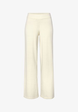 Wijdvallende broek in beige kleur, gemaakt van zachte stof. Voorzien van een elastische tailleband en een gladde textuur zonder zichtbare patronen of accenten.