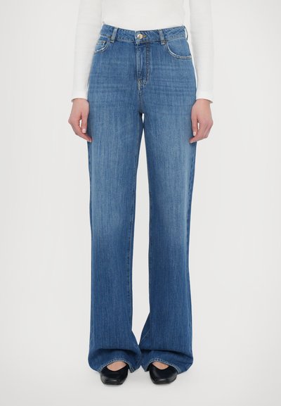 Světle modré kalhoty s širokými nohavicemi vyrobené z denimu, s vysokým pasem, klasickým pětitykovým designem a jemnými švy.