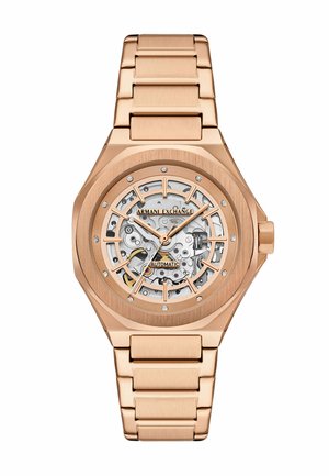 Orologio automatico in oro rosa con un quadrante scheletrato trasparente, accenti di diamanti, lunetta ottagonale e bracciale in metallo a maglie.