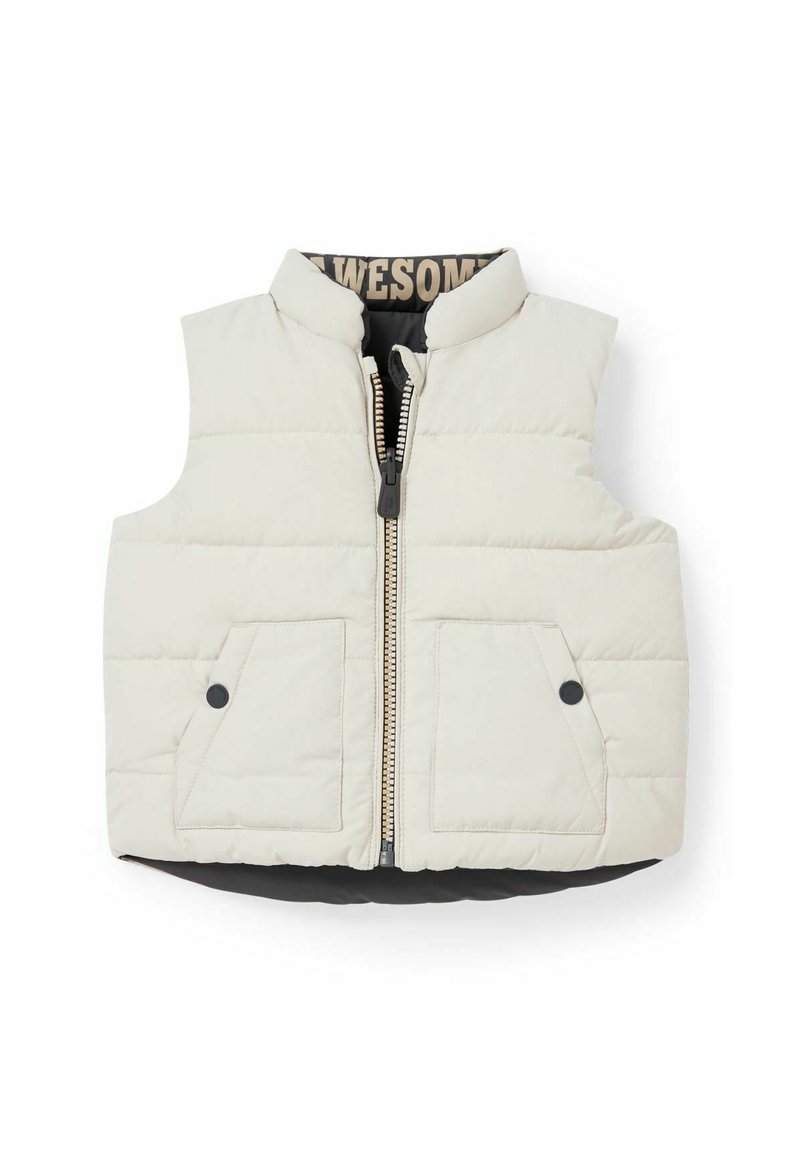 Lekki puchowy bezrękawnik w kolorze kremowym z czarnymi akcentami. Posiada zamek błyskawiczny z przodu, wysoki kołnierz i dwie kieszenie naszywane. Pikowana tekstura.