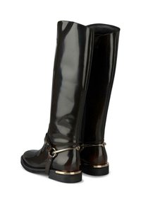 Botas de goma negras brillantes hasta la rodilla con cierre de cremallera, acentuadas con una correa de metal y detalles en dorado en el talón. Textura suave.
