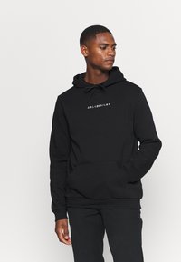 Black hoodie made of cotton blend, featuring a front kangaroo pocket and drawstring hood. Text graphic in white centered on the chest.