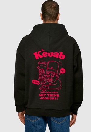 Black hooded sweatshirt featuring a large pink graphic with a cartoon chef holding a kebab, along with text and prices.