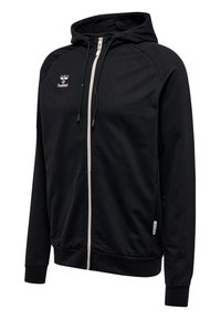 Felpa con cappuccio nera realizzata in un tessuto liscio, con zip frontale, cerniera bianca e logo sul petto. I polsini e l'orlo sono elasticizzati.