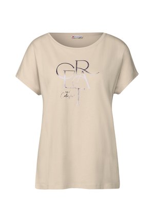 T-shirt beige à manches courtes en coton. Présente un grand texte stylisé en couleurs foncées et claires, un col rond et une coupe décontractée.