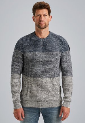 Crewneck sweater featuring a textured knit design in gradient shades of navy, gray, and white. Ribbed cuffs and hem add detail.