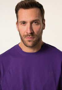 T-shirt di cotone viola con scollatura a girocollo, caratterizzato da un logo JP in stampa a rilievo sul petto, texture morbida.