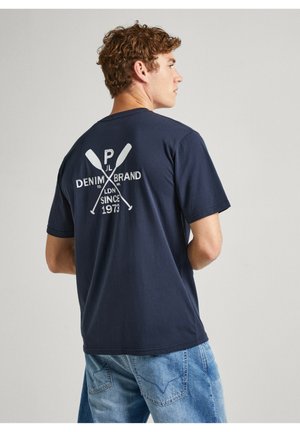 Camiseta de algodón azul marino, de manga corta, con un estampado gráfico blanco en la parte posterior que presenta remos cruzados y texto, ajuste casual.