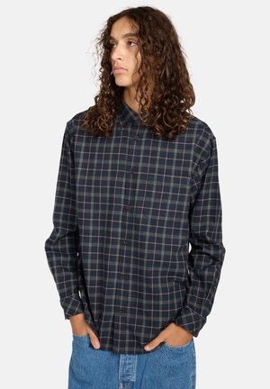 Geruite shirt in marineblauw en groen met roze accenten. Lange mouwen, kraag, knoopsluiting aan de voorkant en een relaxte pasvorm. Getextureerd katoenen flanelmateriaal.