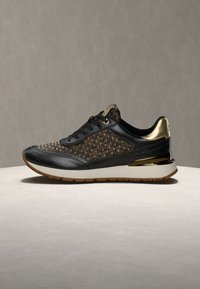 Μαύρο δερμάτινο αθλητικό παπούτσι με χρυσές λεπτομέρειες, που διαθέτει διακοσμητικό μοτίβο με τρουκς στο πάνω μέρος, κομψό σχεδιασμό, λαστιχένια σόλα και ενισχυμένη ενδιάμεση σόλα για άνεση.