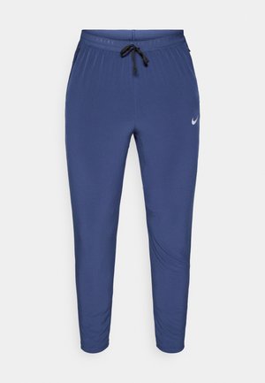 Námořnické sportovní kalhoty s elastickým pasem, šňůrkou, zúženými nohavicemi a malým reflexním logem na levém stehně. Měkká, hladká tkanina.