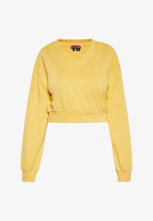 Geel cropped sweatshirt met V-hals, lange mouwen en geribde boorden. Gemaakt van zachte stof met een gladde textuur en minimale details.