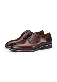 Bruine leren schoenen met een gladde afwerking, ronde neus en subtiele textuur op de hiel. Beschikt over een vetersluiting en een contrasterende blauwe zool.