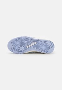 Shoe sole featuring a light purple, textured rubber material with a herringbone pattern and a white logo detail.