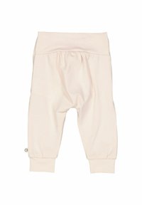 Svetle růžové dětské kalhoty na elastický pas s nabíraným designem, zúženými manžetami a měkkou bavlněnou směsí. Malá cedulka na boku.